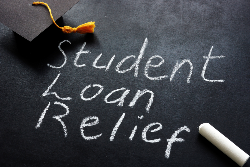 Student,Loan,Relief,Written,On,The,Blackboard,And,Graduation,Cap.